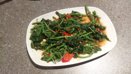 A plate of stir-fried Sambung Daun, a healthy and flavorful Indonesian vegetable dish with chilies...