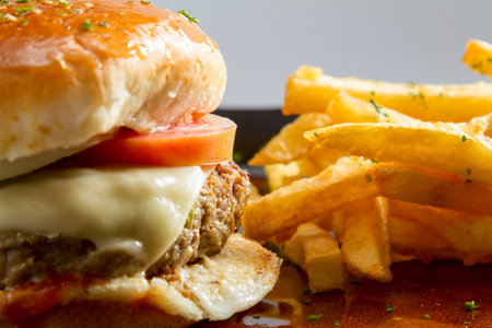 Cheese burger - American cheese burger with Golden French fries potatoes.の写真素材