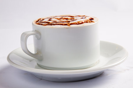 Cappuccino or latte coffee with milk foam on white backgroundの写真素材