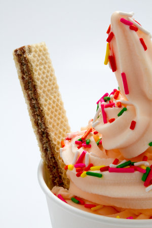 Ice cream with wafer and colorful sprinkles on white background.の写真素材