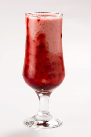 Cranberry smoothie in a glass on a white background.の写真素材