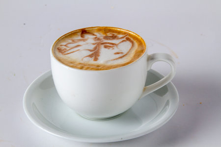 Designer cup of coffee latte art on white background, stock photoの写真素材