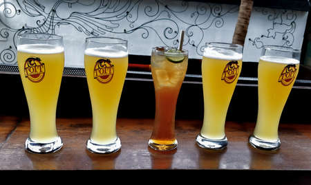 Bangalore, Karnataka / India - October 19 2019: Glasses of beer on the table in a Toit Brew Pub Bangalore. selective focus.のeditorial素材