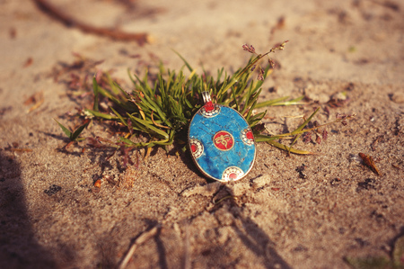 Handmade. Earring on the sand.の写真素材