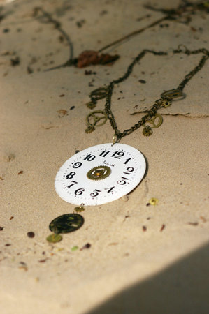 Handmade. Necklace on the sand on unny day