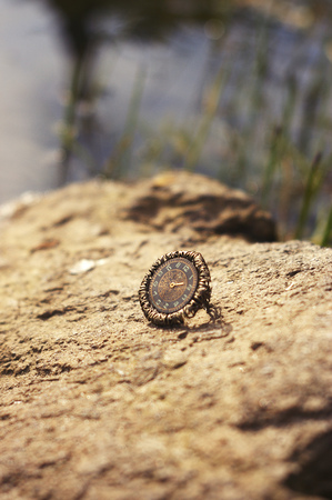 Handmade. Ring with clock dial on the stone on summer sunny dayの写真素材
