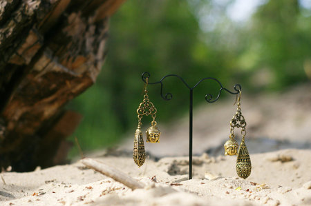 Handmade. Earrings on the stand with buddhas on sand