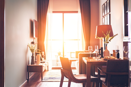 The table and dish, lamp and wine glass are in the hotel room. Natural light from outside windowsの写真素材