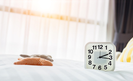 white clock and white bedの写真素材