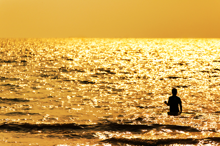 the lonely man stand in the sea water.の写真素材