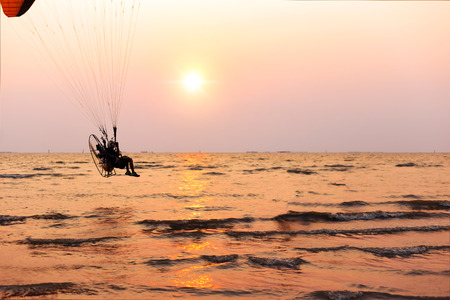 a man play paramotor over the beachの写真素材