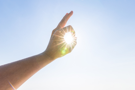 Hand of a man reaching to towards sky. Hand make symbol.の写真素材