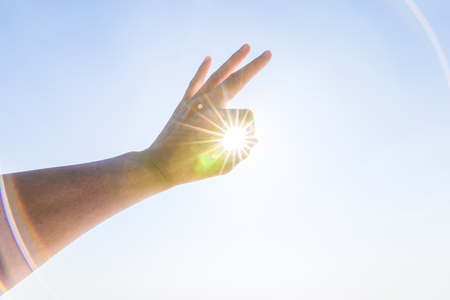 Hand of a man reaching to towards sky. Hand make symbol.の写真素材