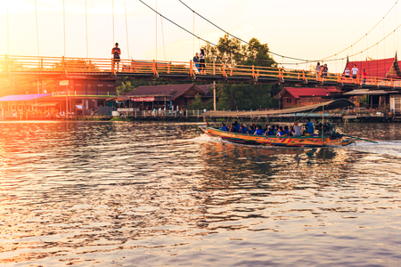 Samut Songkhram , Thailand - April 14, 2018: River cruise boats transporting people on the Mae Klong River. This is a very popular tourist attraction in the city.のeditorial素材