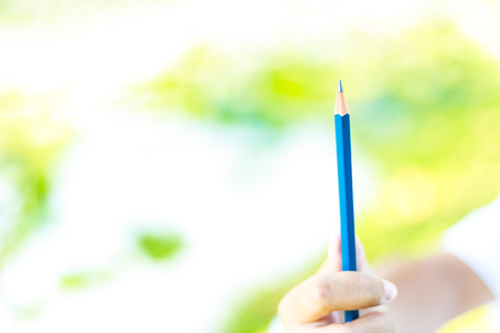 Student practice drawing by pencil in the park.The crayon is on the white paper.の写真素材