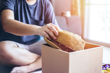 Man hold hat into the box for gift.の写真素材