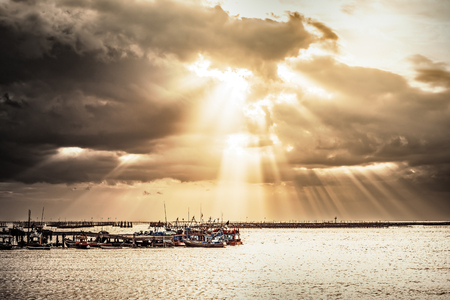 the fishing boat on the sea water and sunray  is background.の写真素材