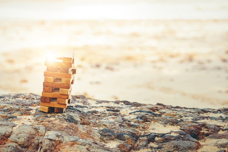 Blocks of wood is On the stone and sand.の写真素材