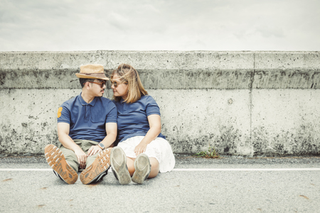 A couple sitting on the road and take photo together for wedding.の写真素材