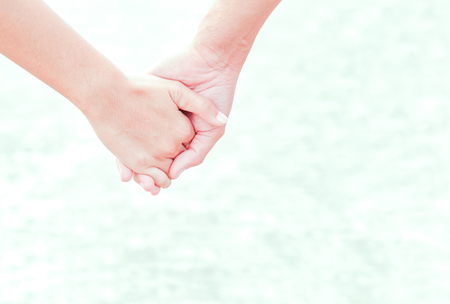 the people hold one's hand on the  beach.の写真素材