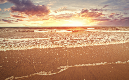 The beach with sunset and cloud in golden hours and sea water flow.の写真素材