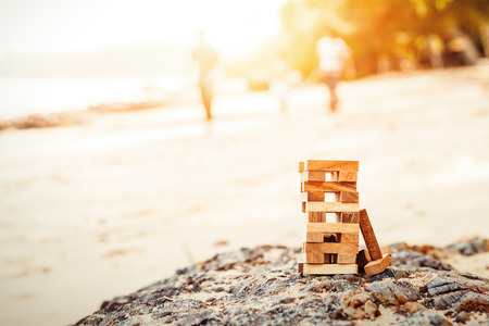 Blocks of wood is On the stone and sand.の写真素材