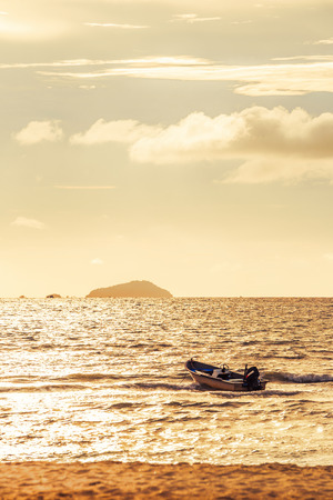 the fishing boat on the sea water and sunset time.の写真素材