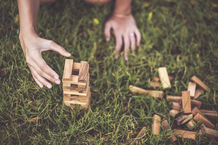 Hand Catch Blocks of wood is On the grass.の写真素材