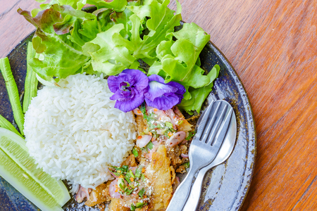 fish spicy salad, Pea flowers, lettuce, cucumber are on the dish. Food is on the wood table.の写真素材