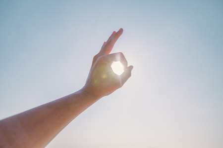 Hand of a man reaching to towards sky. Hand make symbol.の写真素材