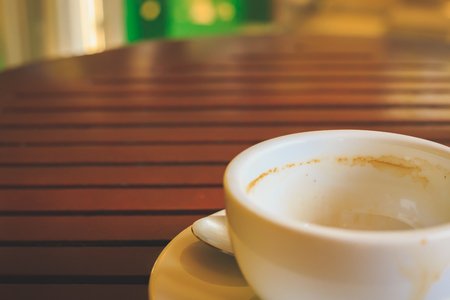 Empty coffee cup after drink on wood table.の写真素材