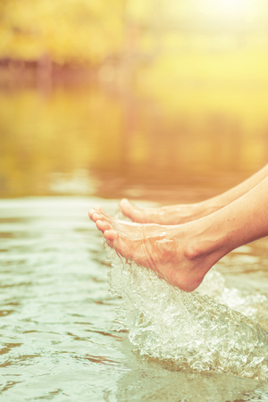 Man' foot with water splash in relaxの写真素材
