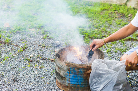 Fill charcoal briquette to hot flaming charcoal in bbq grill stove. Burning charcoal for cooking...