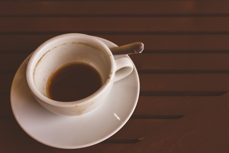 Empty coffee cup after drink on wood table.の写真素材