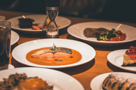 salmon fish with curry in the dish on the table dinner.の写真素材