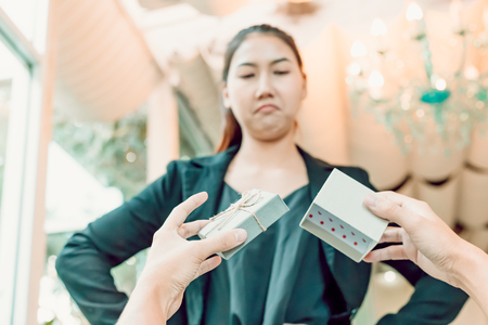 Hands man hold empty gift box and women with face angry.の写真素材