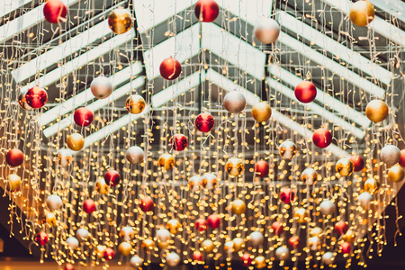 Red Chrismas balls in Vintage city night light bokeh and christmas light blurred background on chrismas day .の写真素材