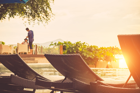 Beautiful luxury hotel swimming pool with sunset scene background.の写真素材