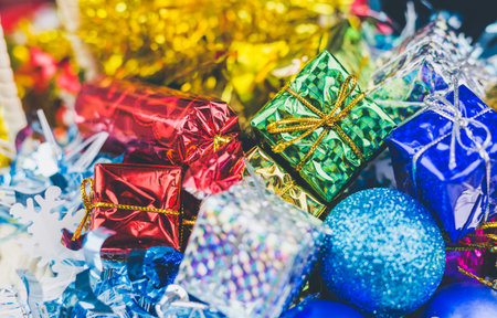 Close up of Cristmas present box with some colorful papper and toys