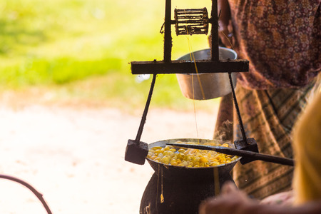 Boiling yellow silkworm cocoons by boiler to make silk thread.の写真素材