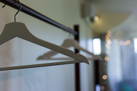 Wood clothes hanger in the dark room at hotel.の写真素材