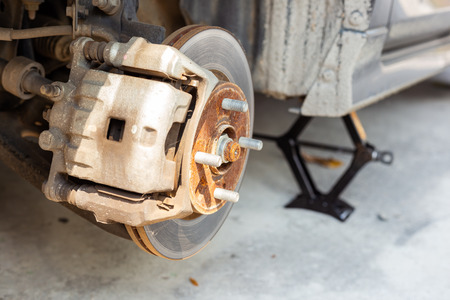 car disc brake during the wheel tire repair. Disc brake of the car during the maintenance at auto service garage.の写真素材