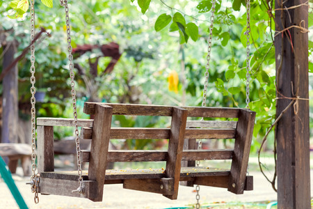 A wood swing at parks in the morning.の写真素材