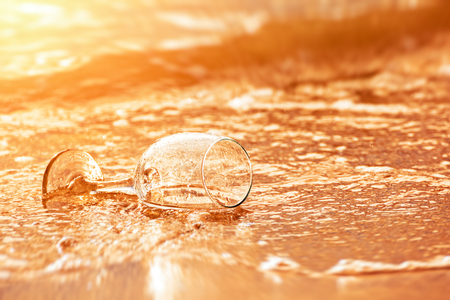 Hand hold glass and water flow at sunset.の写真素材