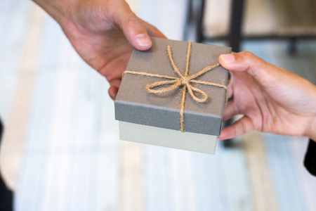 man gives a gift to women to anniversary.の写真素材