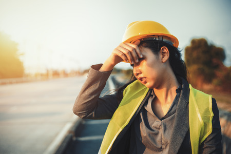engineer women wipe sweat and hot weather at site construction.の写真素材