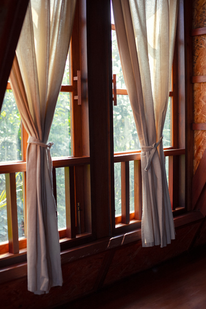 Cozy interior of the home living room window with curtainsの写真素材
