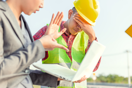 A man  raise hands up for stop and give up.
Foreman afraid manager at site construction.の写真素材