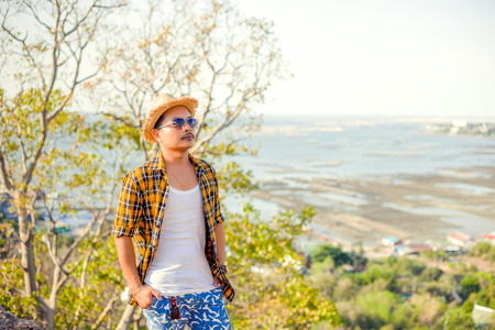Happy man stand on cliff and enjoying Travel mountain .concept vacations, Holidays.の写真素材