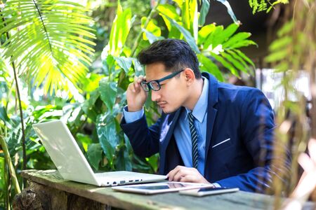 businessman is using eyeglasses  text from screen notebook computer. A man  has short sighted,の写真素材